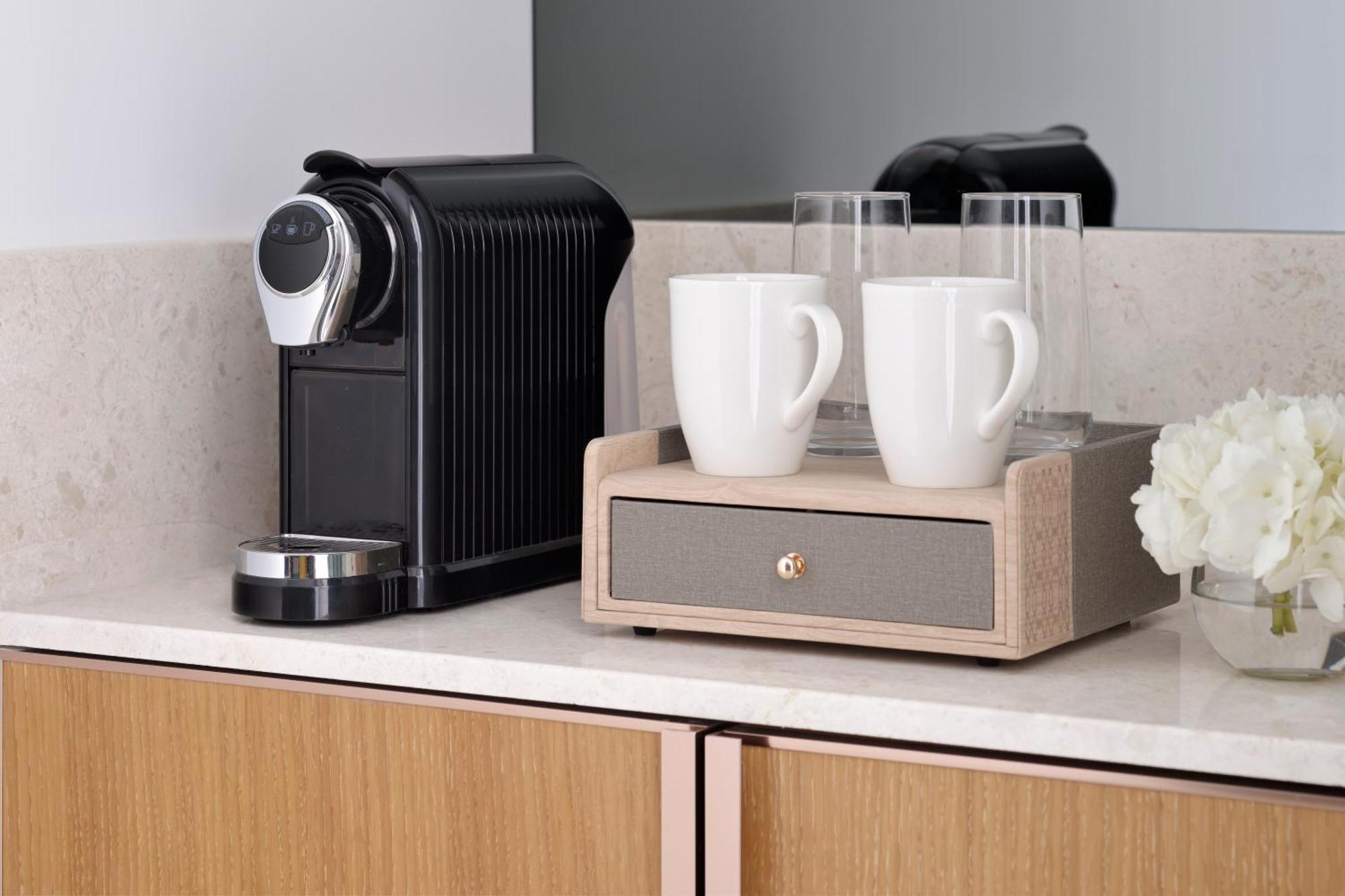 Moevenpick Hotel & Apartments Ghala Maszkat Kültér fotó A Nespresso coffee machine